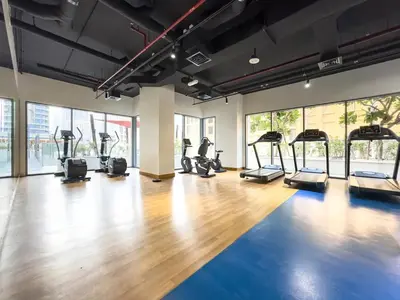 a gym with treadmills and elliptical machines at Downtown 1BR Pool with Burj Khalifa View Near Dubai Mall in Dubai