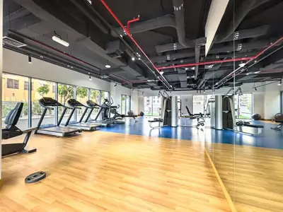 a gym with treadmills and a hard wood floor at Downtown 1BR Pool with Burj Khalifa View Near Dubai Mall in Dubai