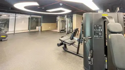 a fitness room with a gym with a treadmill at Belgravia Square, JVC - 1 Bedroom Apartment - Allsopp & Allsopp in Dubai