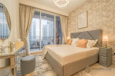 a bedroom with a bed and a large window at Modern 1BR Apartment in Dubai Creek Harbour by DVR Vacation Homes in Dubai