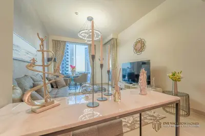 a living room with a table with sculptures on it at Modern 1BR Apartment in Dubai Creek Harbour by DVR Vacation Homes in Dubai
