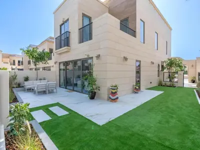 a large house with a lawn in front of it at Luxury 3BR Villa with Pool View & Modern Comfort in Dubai