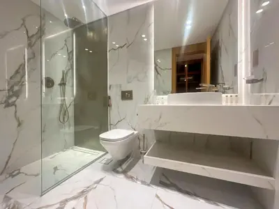a bathroom with a shower and a toilet and a sink at Luxury 3BR Villa with Pool View & Modern Comfort in Dubai