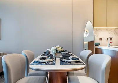 a dining room with a table and chairs at Luxury 2BR at Address Opera with Burj Khalifa View in Dubai