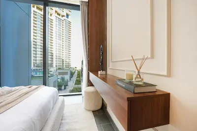 a bedroom with a bed and a large window at Trophy - Modern 2BR in Crest Tower in Dubai