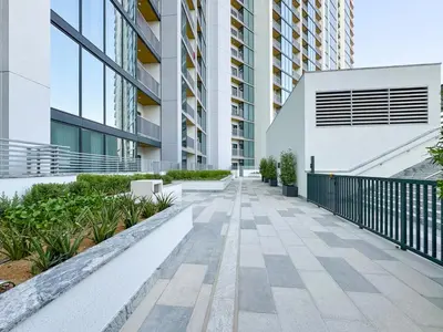 a walkway in a building with buildings at Trophy - Modern 2BR in Crest Tower in Dubai