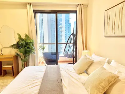 a bedroom with a bed and a large window at Tiramisu - Luxurious 2 BR Apartment- JBR Beach in Dubai