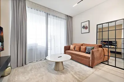 a living room with a couch and a table at Trillionaire Studio, Canal Views, Private Jacuzzi in Dubai
