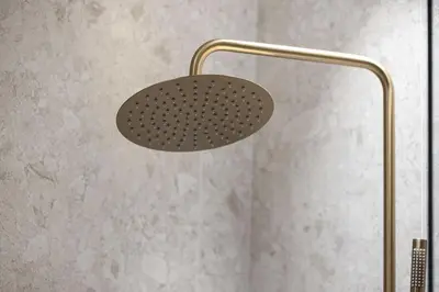 a shower head in a bathroom with a wall at Trillionaire Studio, Canal Views, Private Jacuzzi in Dubai