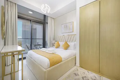 a bedroom with a large bed and a balcony at Skyline Retreat, 2BDR Ensuite Comfort, City View in Dubai