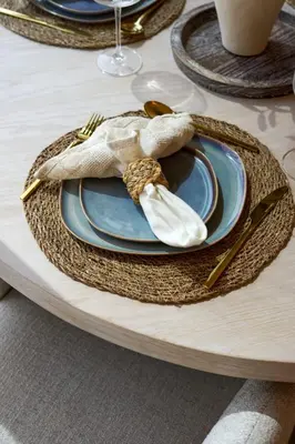a table with a plate with a napkin on it at Coastal 1BR with Balcony and Marina Ain Dubai Bluewaters Views in Dubai