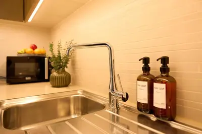 two bottles of wine sitting on a kitchen sink at Coastal 1BR with Balcony and Marina Ain Dubai Bluewaters Views in Dubai