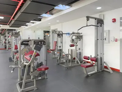 a gym with rows of treadmills and machines at Amazing Views of Palm & Dubai Eye Stylish Studio in Dubai