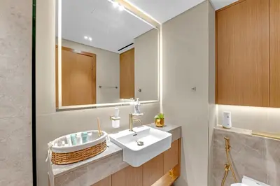 a bathroom with a sink and a mirror at Modern Luxe | Heart of Dubai | Trillionaire Living in Dubai