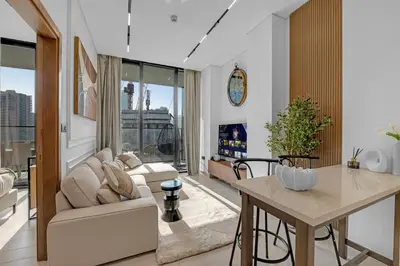a living room with a couch and a table at Modern Luxe | Heart of Dubai | Trillionaire Living in Dubai