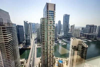 a view of a city with a river and buildings at Stylish 2-Bedroom Apartment with Marina View JBR in Dubai