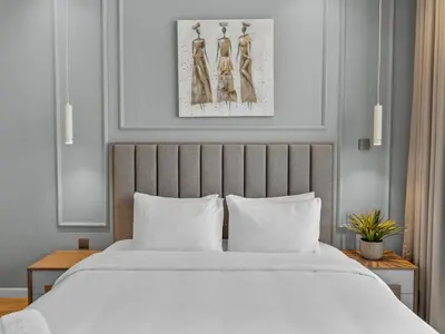 a bedroom with a large white bed with white pillows at Convenient City Apartment Near Metro & Downtown in Dubai