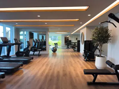 a gym with a lot of treadmills and exercise equipment at Palace Beachfront Dubai Harbour in Dubai