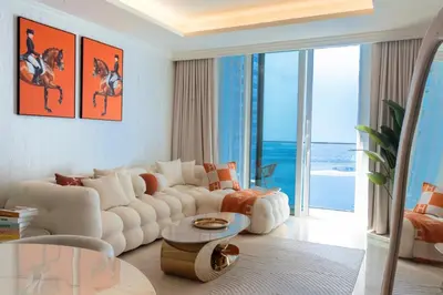 a living room with a white couch and a table at Palace Beachfront Dubai Harbour in Dubai