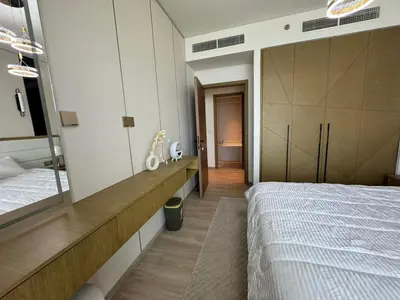 a bedroom with a bed and a large mirror at Luxury two beds apartment in Dubai