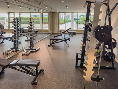 a gym with treadmills and cardio equipment in a building at Beachfront Luxe 1BR Grand Bleu with Private Beach & Sea View in Dubai