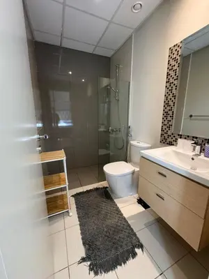 a bathroom with a toilet and a sink and a shower at Luxury Smart Home Villa Damac Hills 2 3BR Ensuite in Dubai