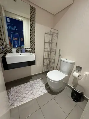 a bathroom with a toilet and a sink at Luxury Smart Home Villa Damac Hills 2 3BR Ensuite in Dubai