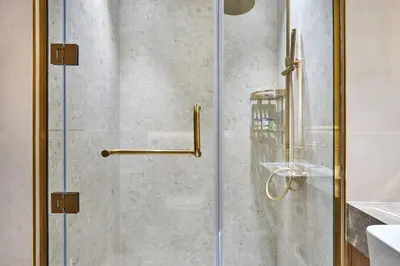 a shower with a glass door in a bathroom at Glamorous Trillionaire Living in Dubai