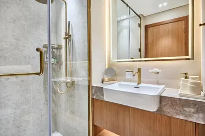 a bathroom with a sink and a shower at Glamorous Trillionaire Living in Dubai