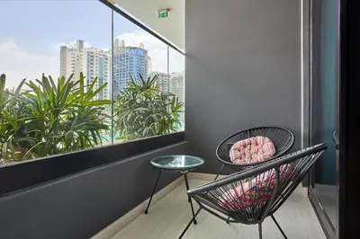 a balcony with a chair and a table and a window at Glamorous Trillionaire Living in Dubai