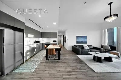 a kitchen and living room with a table and a couch at Grande Tower by Emaar, Downtown, Burj Khalifa in Dubai