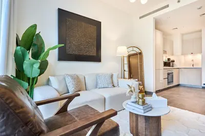 a living room with a couch and a table at STAY BY LATINEM Luxury 1BR Holiday Home CB 0607 Near Burj Khalifa in Dubai