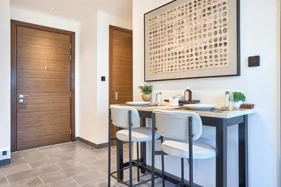 a kitchen with a bar with stools in a room at STAY BY LATINEM Luxury 1BR Holiday Home CB 0607 Near Burj Khalifa in Dubai