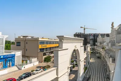 an overhead view of a city street with buildings at Classy Studio APT Close To Dubai Miracle Garden in Dubai