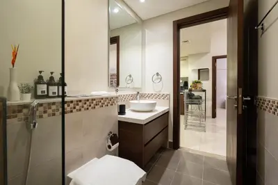a bathroom with a sink and a shower at Dubai Luxury 2BR - Pool, Gym & Burj Khalifa View in Dubai