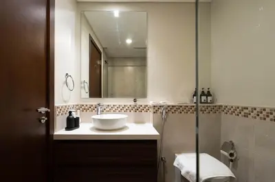 a bathroom with a sink and a mirror at Dubai Luxury 2BR - Pool, Gym & Burj Khalifa View in Dubai