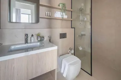 a bathroom with a sink and a toilet and a shower at Frank Porter - Liva, Townsquare in Dubai