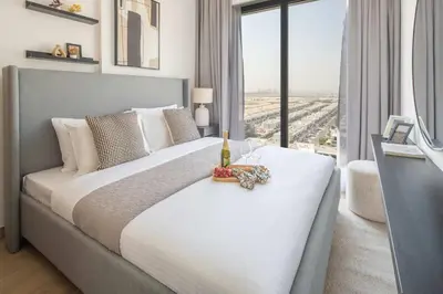 a bedroom with a large white bed with a window at Frank Porter - Liva, Townsquare in Dubai