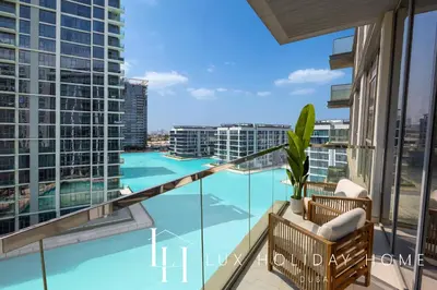a balcony with a view of a swimming pool at LUX The Burj Khalifa Lagoon View Suite 4 in Dubai