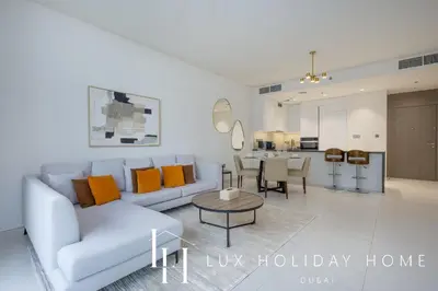 a living room with a couch and a table at LUX The Burj Khalifa Lagoon View Suite 4 in Dubai