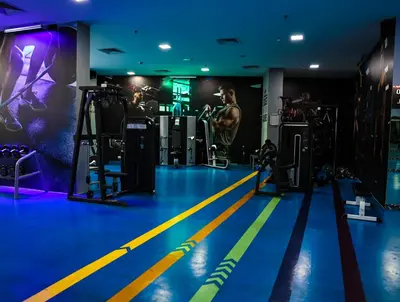 a gym with blue and yellow lines on the floor at Elegant Studio with Pool & Gym in JVC in Dubai