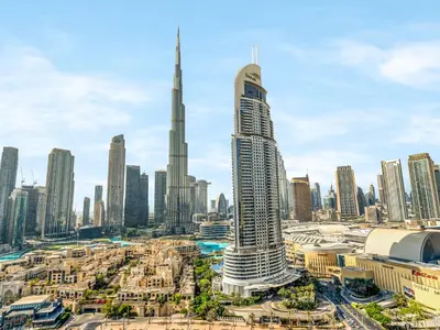 a view of a city with a tall skyscraper at ABI Holiday Homes - Burj Khalifa and Fountain view Downtown in Dubai