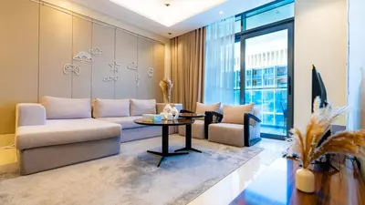 a living room with a couch and a table at The Nobles Tower High Floor with Elegant City View in Dubai