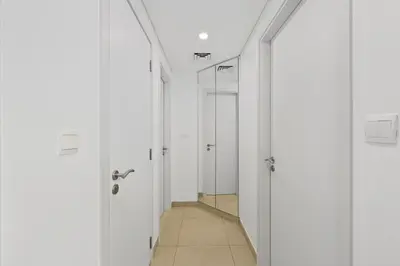 a hallway with white doors and a mirror at Lamtara in Dubai
