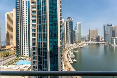 a view of a river in a city with tall buildings at GuestReady - Cozy Studio | Pool & Gym | Canal view in Dubai