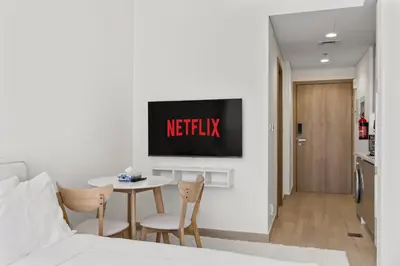 a bedroom with a bed and a tv on a wall at Elite Escape - Getaway in Azizi Riviera 29 in Dubai