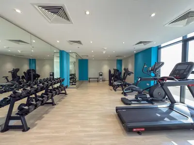 a gym with treadmills and cardio equipment in a building at Elite Escape - Getaway in Azizi Riviera 29 in Dubai