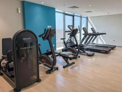 a gym with several exercise bikes in a room at Elite Escape - Getaway in Azizi Riviera 29 in Dubai