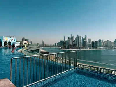 a swimming pool with a view of a city at Restay Homes at Seven Palm Hotel & Apartments - Pool and Beach Access included in Dubai