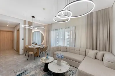 a living room with a couch and a table at Brand New 2BR Peninsula One with Burj Khalifa View in Dubai